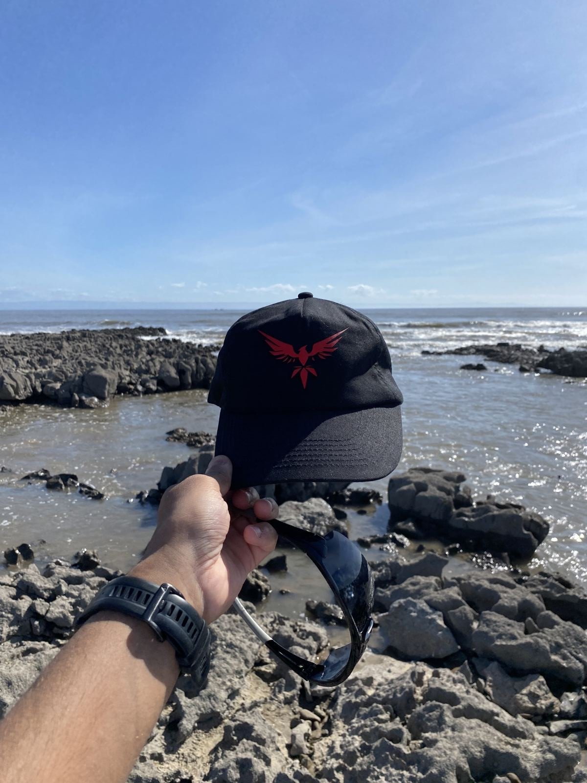 Branded cap on the rocks near the coast