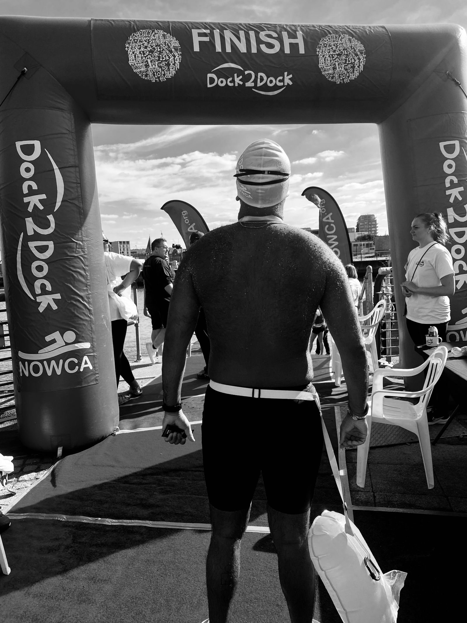 Walking through the Dock2Dock swim finish arch