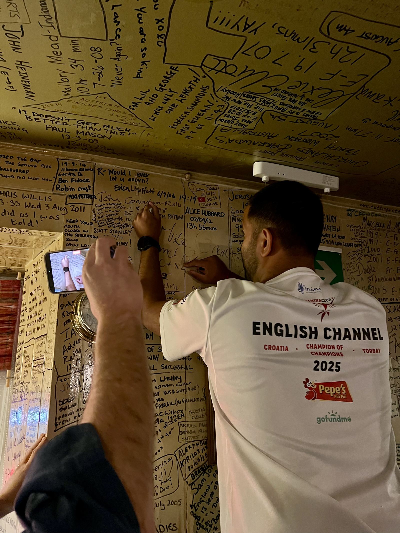 Signing the wall at Dover after a Channel swim