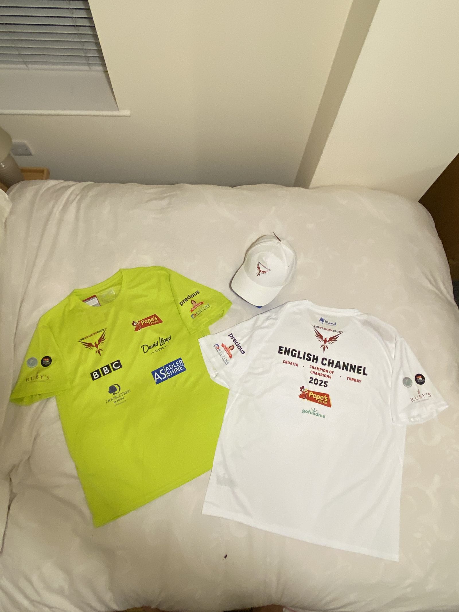Branded t-shirts and cap laid out