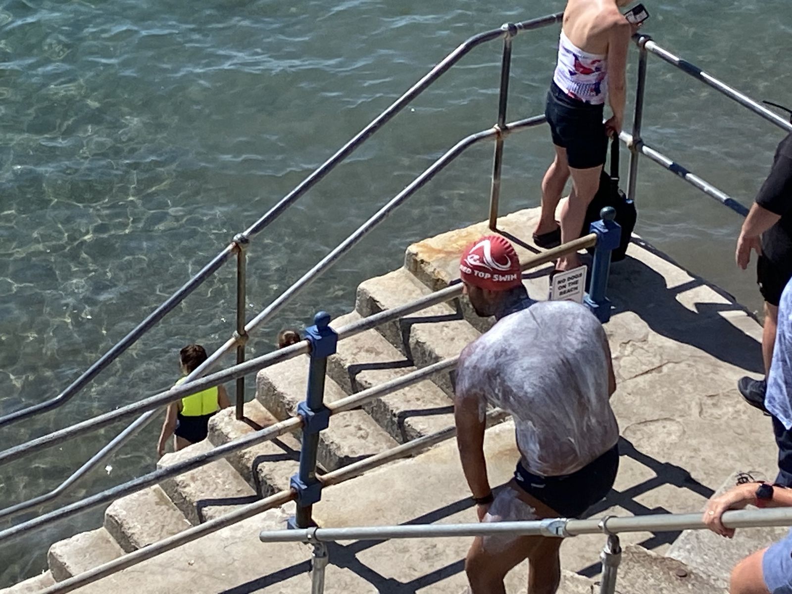 Climbing the steps out of the water after a swim