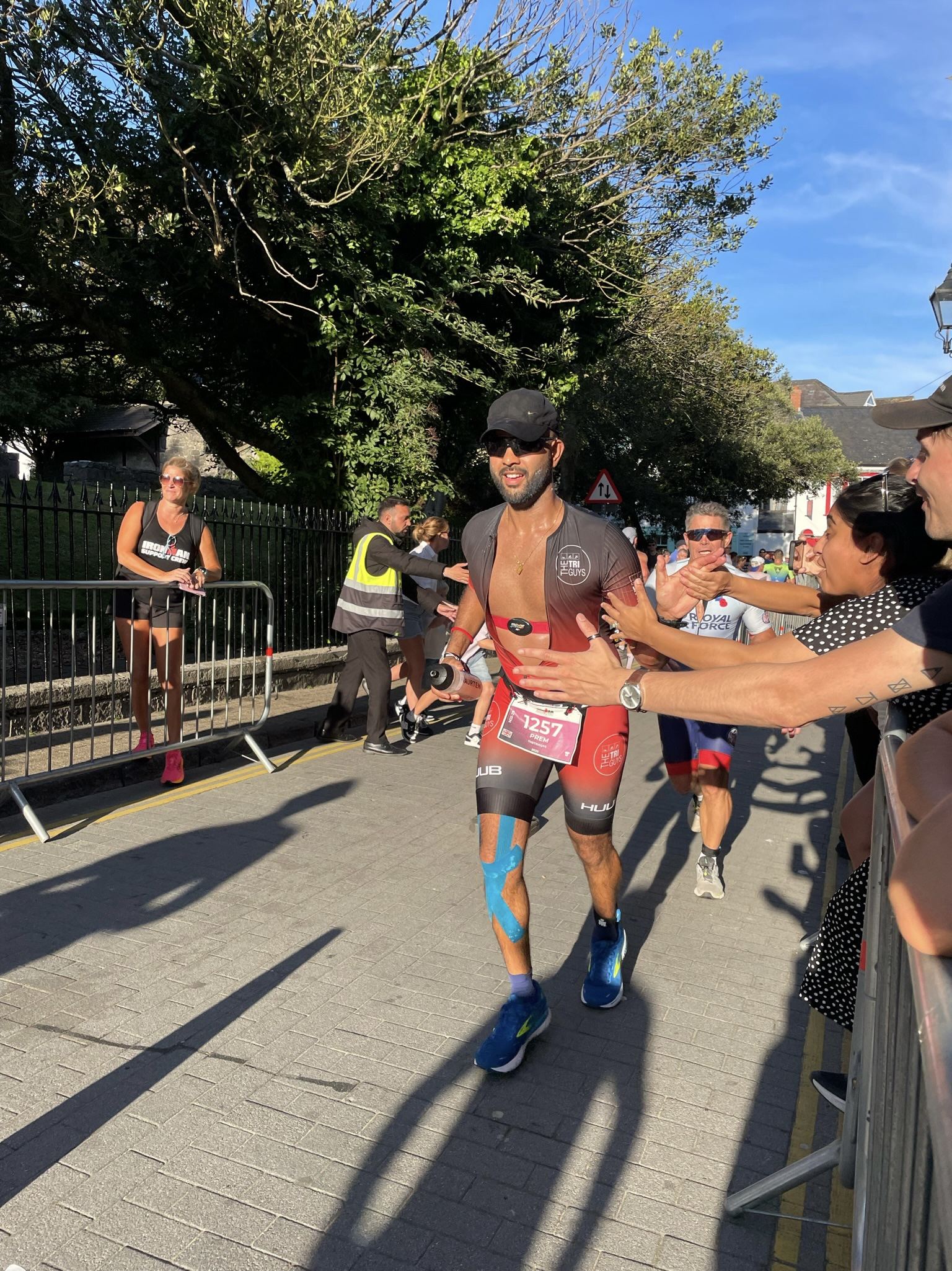 High-fiving the crowd at a triathlon finish
